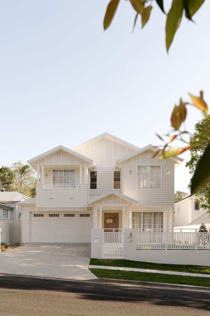 A white, Hamptons-style Gliderol sectional door with windows, shown as an example for troubleshooting common sectional door problems - Gliderol